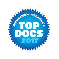 A spiky blue circle with &quot;Philadelpha Magazine's Top Docs 2017&quot; written inside in white.