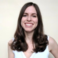 A portrait shot of Marie Danielle Ralff on a white background, smiling at the camera.