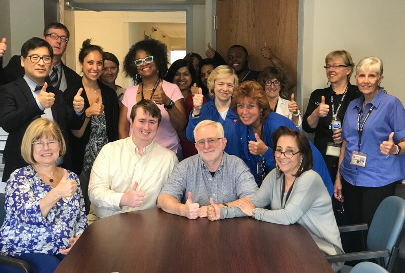 Noah (front row, second from left) and Harry (front row second from right) Tankin celebrating the establishment of the Andrea N. Tankin Fund in 2018 with the medical staff who cared for Andy.